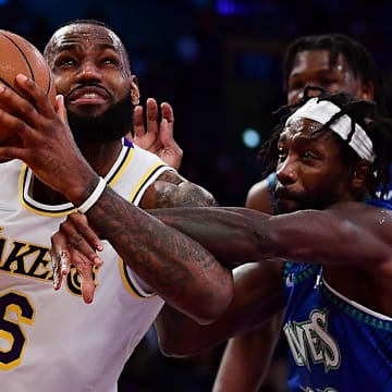 Jan 2, 2022; Los Angeles, California, USA; Los Angeles Lakers forward LeBron James (6) moves to the basket against Minnesota Timberwolves guard Patrick Beverley (22) during the second half at Crypto.com Arena. 