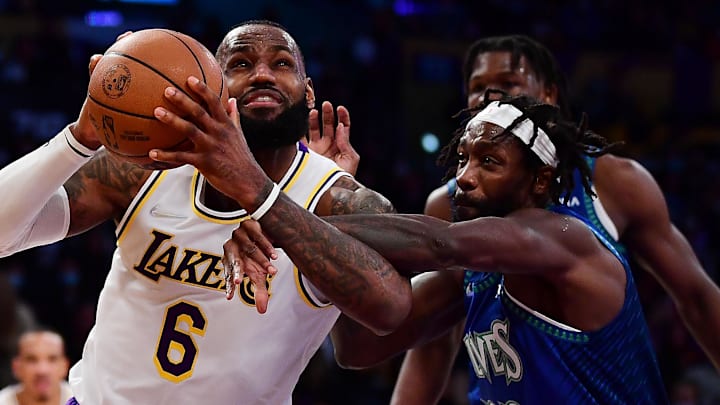 Jan 2, 2022; Los Angeles, California, USA; Los Angeles Lakers forward LeBron James (6) moves to the basket against Minnesota Timberwolves guard Patrick Beverley (22) during the second half at Crypto.com Arena. 