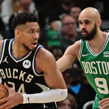 Apr 9, 2024; Milwaukee, Wisconsin, USA; Milwaukee Bucks forward Giannis Antetokounmpo (34) looks for a shot against Boston Celtics guard Derrick White (9) in the third quarter at Fiserv Forum. Mandatory Credit: Benny Sieu-Imagn Images