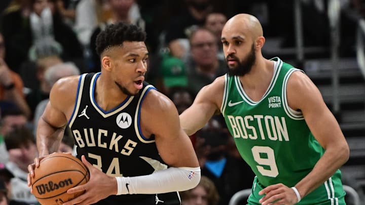 Apr 9, 2024; Milwaukee, Wisconsin, USA; Milwaukee Bucks forward Giannis Antetokounmpo (34) looks for a shot against Boston Celtics guard Derrick White (9) in the third quarter at Fiserv Forum. Mandatory Credit: Benny Sieu-Imagn Images