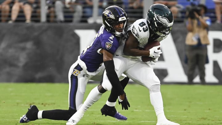 Aug 9, 2024; Baltimore, Maryland, USA;  Philadelphia Eagles wide receiver John Ross (83) makes catch in front of Baltimore Ravens cornerback Nate Wiggins (2) during the first quarter of a preseason game at M&T Bank Stadium.