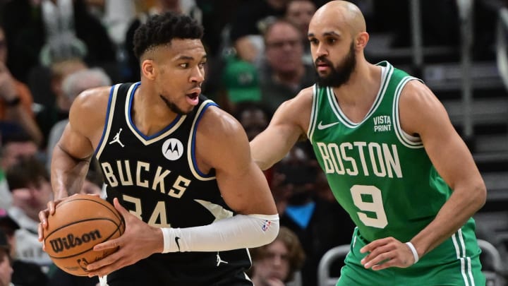 Apr 9, 2024; Milwaukee, Wisconsin, USA; Milwaukee Bucks forward Giannis Antetokounmpo (34) looks for a shot against Boston Celtics guard Derrick White (9) in the third quarter at Fiserv Forum. Mandatory Credit: Benny Sieu-USA TODAY Sports