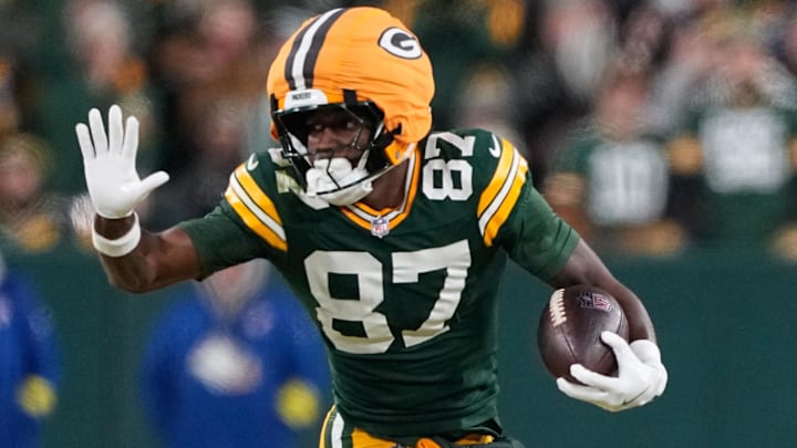 Dec 27, 2025; Green Bay, Wisconsin, USA; Green Bay Packers wide receiver Romeo Doubs (87) runs after a catch against Baltimore Ravens safety Alohi Gilman (12) during the second quarter at Lambeau Field.