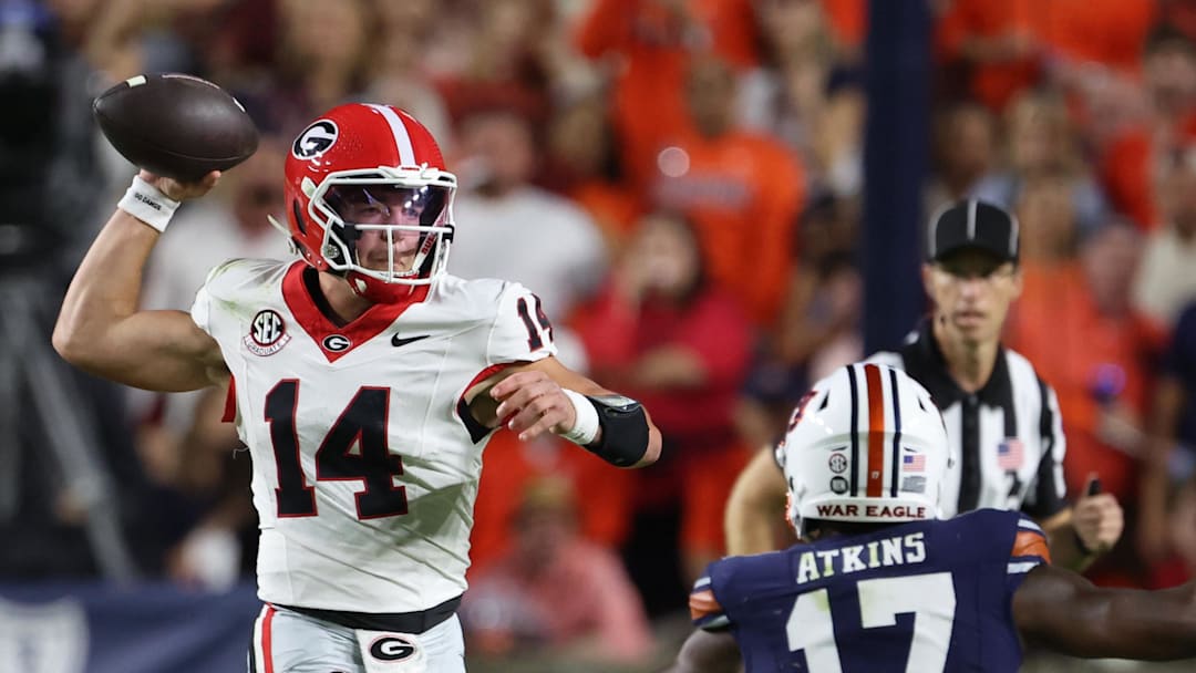 Oct 11, 2025; Auburn, Alabama, USA;  Georgia Bulldogs quarterback Gunner Stockton (14) looks for a receiver during the first quarter against the Auburn Tigers at Jordan-Hare Stadium. Mandatory Credit: John Reed-Imagn Images