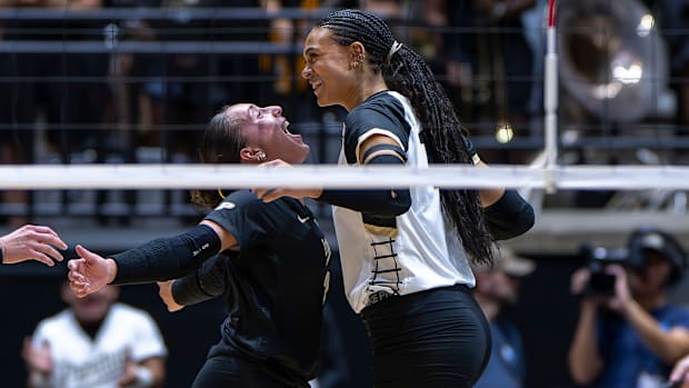 Purdue sophomore Ryan McAleer (3) and senior Akasha Anderson (13) celebrate after a point 