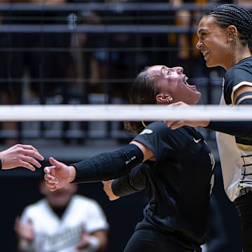Purdue sophomore Ryan McAleer (3) and senior Akasha Anderson (13) celebrate after a point