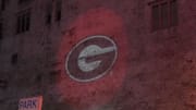 Georgia Bulldogs logo is projected on a  building prior to the 2022 College Football Playoff National Championship game. 