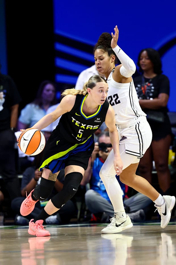 Dallas Wings guard Paige Bueckers controls the ball as Golden State Valkyries guard Veronica Burton defends