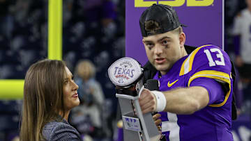 Dec 31, 2024; Houston, TX, USA; LSU Tigers quarterback Garrett Nussmeier (13) holds up the MVP trophy after defeating the Baylor Bears in the Kinder’s Texas Bowl in the second half at NRG Stadium. Mandatory Credit: Thomas Shea-Imagn Images