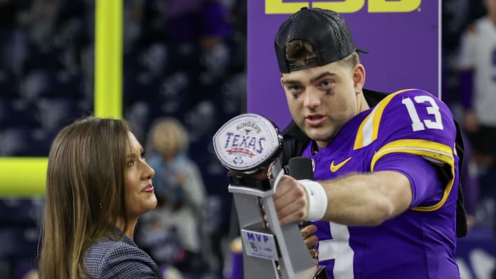 Dec 31, 2024; Houston, TX, USA; LSU Tigers quarterback Garrett Nussmeier (13) holds up the MVP trophy after defeating the Baylor Bears in the Kinder’s Texas Bowl in the second half at NRG Stadium. Mandatory Credit: Thomas Shea-Imagn Images