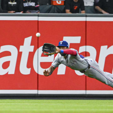 Jun 29, 2024; Baltimore, Maryland, USA;  Texas Rangers outfielder Derek Hill (40) divers a for a first-inning fly ball against the Baltimore Orioles at Oriole Park at Camden Yards. Mandatory Credit: Tommy Gilligan-USA TODAY Sports