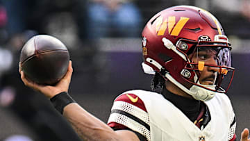 Washington Commanders quarterback Jayden Daniels drops back to pass against the Minnesota Vikings.