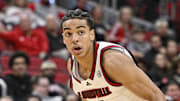 Nov 3, 2025; Louisville, Kentucky, USA;  Louisville Cardinals guard Mikel Brown Jr. (0) dribbles against the South Carolina State Bulldogs during the second half at KFC Yum! Center. Mandatory Credit: Jamie Rhodes-Imagn Images