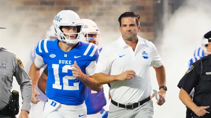Aug 30, 2024; Durham, North Carolina, USA; Duke Blue Devils head coach Manny Diaz runs out onto the field before the game against the Elon Phoenix at Wallace Wade Stadium. Mandatory Credit: James Guillory-Imagn Images Aug 30, 2024; Durham, North Carolina, USA; Duke Blue Devils head coach Manny Diaz runs out onto the field before the game against the Elon Phoenix at Wallace Wade Stadium. Mandatory Credit: James Guillory-Imagn Images