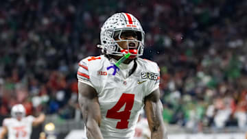 Jan 20, 2025; Atlanta, GA, USA; Ohio State Buckeyes wide receiver Jeremiah Smith (4) celebrates a play against the Notre Dame Fighting Irish during the CFP National Championship college football game at Mercedes-Benz Stadium. Mandatory Credit: Mark J. Rebilas-Imagn Images