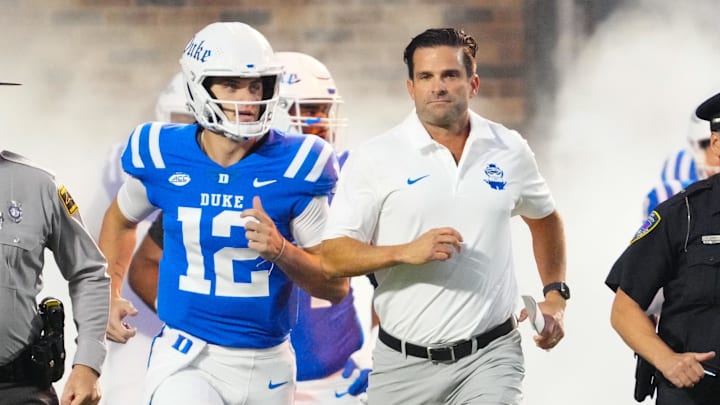 Aug 30, 2024; Durham, North Carolina, USA;  Duke Blue Devils head coach Manny Diaz runs out onto the field before the game against the Elon Phoenix at Wallace Wade Stadium.