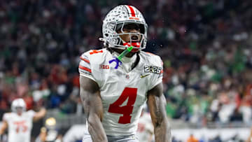 Jan 20, 2025; Atlanta, GA, USA; Ohio State Buckeyes wide receiver Jeremiah Smith (4) celebrates a play against the Notre Dame Fighting Irish during the CFP National Championship college football game at Mercedes-Benz Stadium.