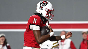 Nov 1, 2025; Raleigh, North Carolina, USA;  North Carolina State Wolfpack quarterback CJ Bailey (11) scores a touchdown against the Georgia Tech Yellow Jackets during the first quarter at Carter-Finley Stadium. Mandatory Credit: Zachary Taft-Imagn Images