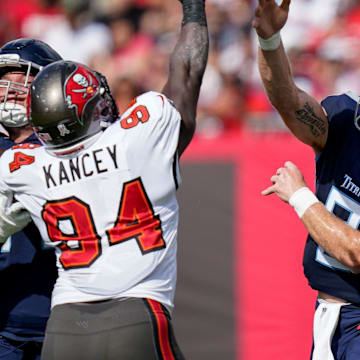Tennessee Titans quarterback Will Levis (8) throws after being bumped by teammate offensive tackle Andre Dillard (71) while battling Tampa Bay Buccaneers defensive tackle Calijah Kancey.
