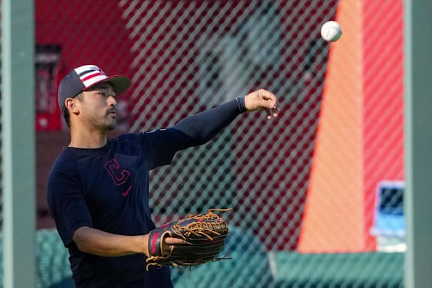 Steven Kwan throws a ball during warmups 