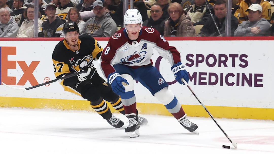 Mar 24, 2026; Pittsburgh, Pennsylvania, USA;  Colorado Avalanche defenseman Cale Makar (8) moves the puck a=head of Pittsburgh Penguins right wing Rickard Rakell (67) during the first period at PPG Paints Arena. Mandatory Credit: Charles LeClaire-Imagn Images