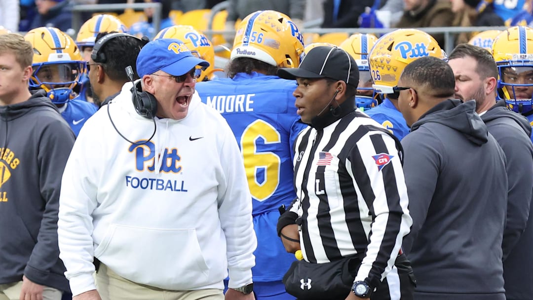 Nov 29, 2025; Pittsburgh, Pennsylvania, USA;  Pittsburgh Panthers head coach Pat Narduzzi (left) reacts to line judge Josiah Ford (right) during the third quarter against the Miami Hurricanes at Acrisure Stadium. Mandatory Credit: Charles LeClaire-Imagn Images