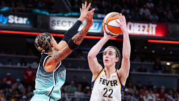 May 24, 2025; Indianapolis, Indiana, USA; Indiana Fever guard Caitlin Clark (22) shoots the ball while New York Liberty guard Natasha Cloud (9)  defends in the second half at Gainbridge Fieldhouse. Mandatory Credit: Trevor Ruszkowski-Imagn Images