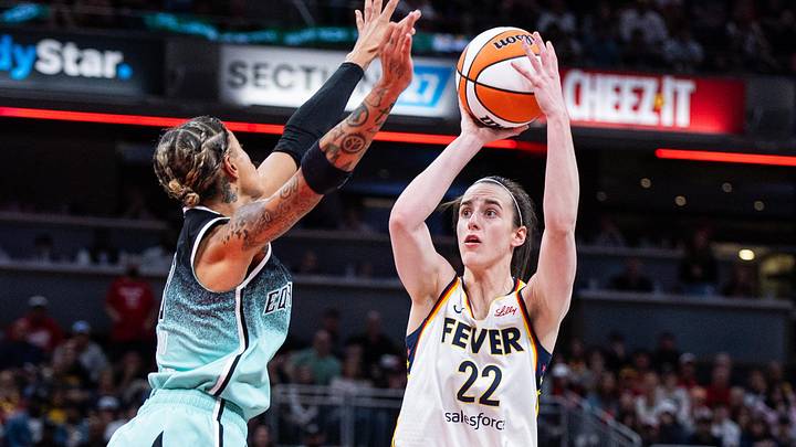 May 24, 2025; Indianapolis, Indiana, USA; Indiana Fever guard Caitlin Clark (22) shoots the ball while New York Liberty guard Natasha Cloud (9)  defends in the second half at Gainbridge Fieldhouse. Mandatory Credit: Trevor Ruszkowski-Imagn Images