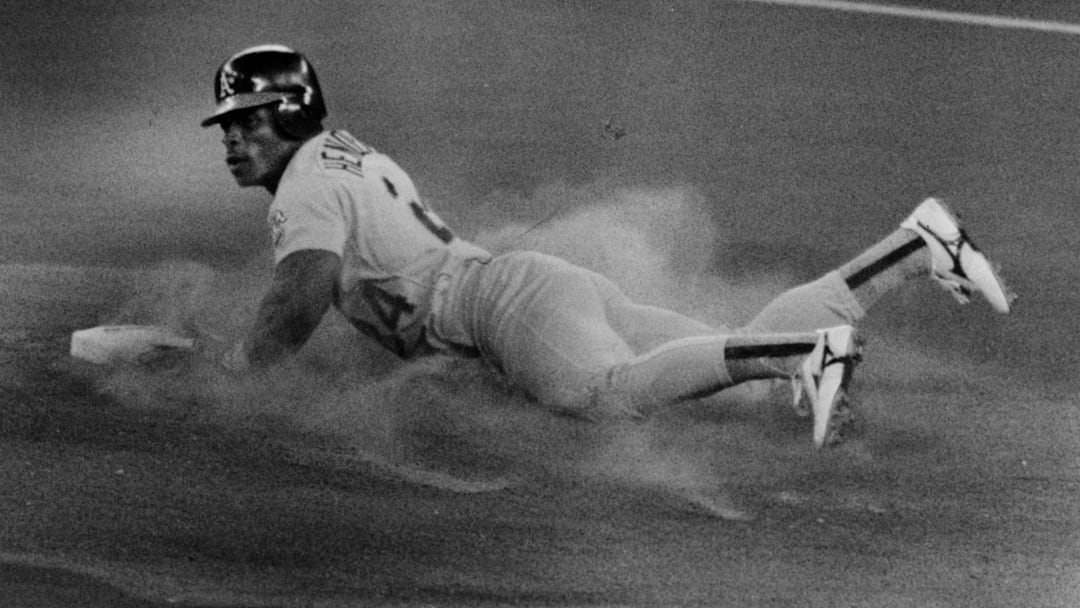 Rickey Henderson steals second base