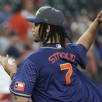 Apr 15, 2024; Houston, Texas, USA; Houston Texans quarterback C.J. Stroud throws out one of the first pitches as the Houston Astros play against the Atlanta Braves at Minute Maid Park. All players wore #42 in honor of Jackie Robinson Day.