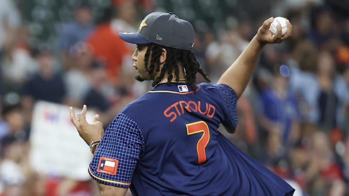 Apr 15, 2024; Houston, Texas, USA; Houston Texans quarterback C.J. Stroud throws out one of the first pitches as the Houston Astros play against the Atlanta Braves at Minute Maid Park. All players wore #42 in honor of Jackie Robinson Day.