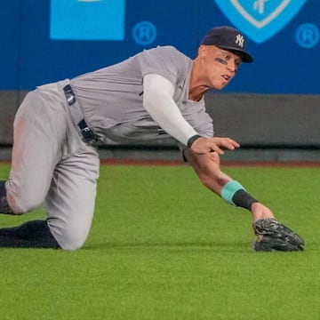 Jun 12, 2024; Kansas City, Missouri, USA; New York Yankees center fielder Aaron Judge (99) makes a diving catch for an out against the Kansas City Royals in the seventh inning at Kauffman Stadium. Mandatory Credit: Denny Medley-Imagn Images