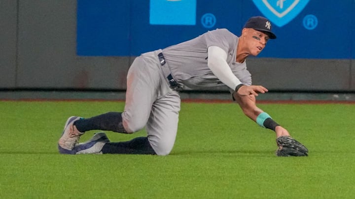 Jun 12, 2024; Kansas City, Missouri, USA; New York Yankees center fielder Aaron Judge (99) makes a diving catch for an out against the Kansas City Royals in the seventh inning at Kauffman Stadium. Mandatory Credit: Denny Medley-Imagn Images