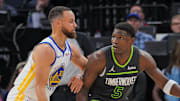 Mar 24, 2024; Minneapolis, Minnesota, USA; Golden State Warriors guard Stephen Curry (30) defends Minnesota Timberwolves guard Anthony Edwards (5) in the third quarter at Target Center. Mandatory Credit: Brad Rempel-Imagn Images