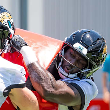 Jacksonville Jaguars linebacker Jack Kiser (54) uses a blocking pad as Jacksonville Jaguars Devin Lloyd (0) drives through him during the fourth organized team activity at the Miller Electric Center in Jacksonville, Fla. Tuesday, May 27, 2025. [Doug Engle/Florida Times-Union]