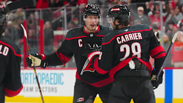 Dec 15, 2024; Raleigh, North Carolina, USA;  Carolina Hurricanes left wing William Carrier (28) celebrates a goal with center Jordan Staal (11) against the Columbus Blue Jackets during the first period at Lenovo Center. Mandatory Credit: James Guillory-Imagn Images
