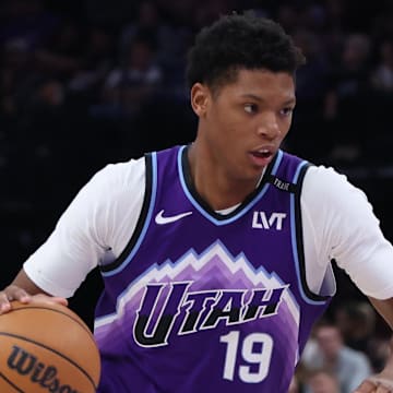 Oct 27, 2025; Salt Lake City, Utah, USA; Utah Jazz guard Ace Bailey (19) drives against Phoenix Suns forward Royce O'Neale (00) during the second half at Delta Center. Mandatory Credit: Rob Gray-Imagn Images