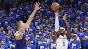 May 13, 2025; Oklahoma City, Oklahoma, USA; Oklahoma City Thunder guard Luguentz Dort (5) shoots a three point basket as Denver Nuggets center Nikola Jokic (15) defends during the second half of game five of the second round for the 2025 NBA Playoffs at Paycom Center. Mandatory Credit: Alonzo Adams-Imagn Images