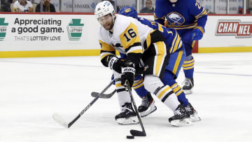 Dec 10, 2022; Pittsburgh, Pennsylvania, USA; Pittsburgh Penguins left wing Jason Zucker (16) skates with the puck against Buffalo Sabres right wing JJ Peterka (rear) during the third period at PPG Paints Arena. The Penguins won 3-1.  Mandatory Credit: Charles LeClaire-USA TODAY Sports