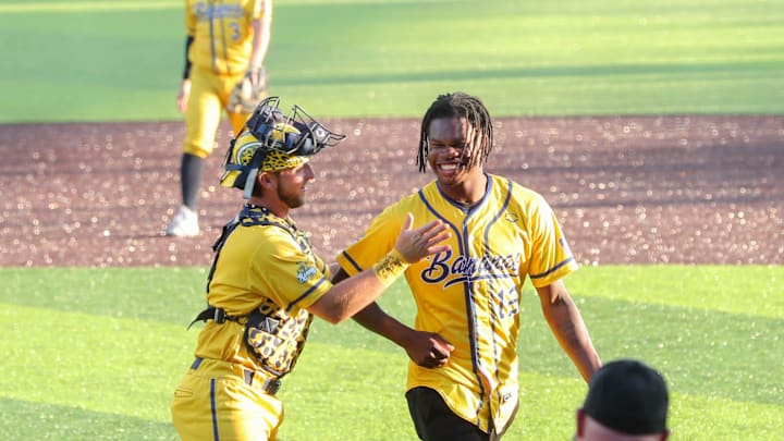 Bill LeRoy congratulates Travis Hunter after his first pitch at a Savannah Bananas game. Bill LeRoy congratulates Travis Hunter after his first pitch at a Savannah Bananas game.
