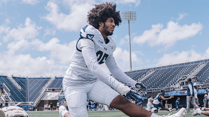 JUCO transfer Kenton Simmons stretching before FIU football spring game