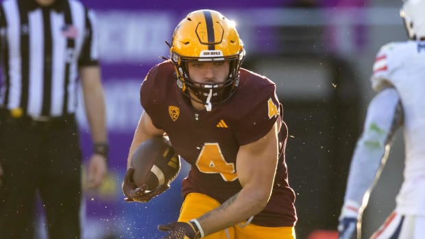 Arizona State Sun Devils running back Cameron Skattebo on a rushing attempt during a college football game.