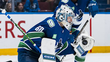 Apr 14, 2025; Vancouver, British Columbia, CAN; Vancouver Canucks goalie Nikita Tolopilo (60) makes a save against the San Jose Sharks in the third period at Rogers Arena. Mandatory Credit: Bob Frid-Imagn Images