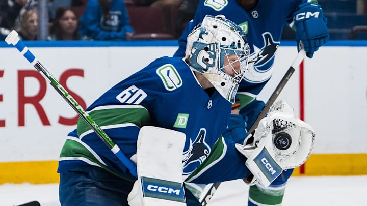 Apr 14, 2025; Vancouver, British Columbia, CAN; Vancouver Canucks goalie Nikita Tolopilo (60) makes a save against the San Jose Sharks in the third period at Rogers Arena. Mandatory Credit: Bob Frid-Imagn Images