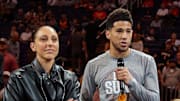 Mar 8, 2020; Phoenix, Arizona, USA; Phoenix Mercury player Diana Taurasi (left) and Phoenix Suns guard Devin Booker against the Milwaukee Bucks at Talking Stick Resort Arena. Mandatory Credit: Mark J. Rebilas-Imagn Images