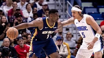 Apr 3, 2024; New Orleans, Louisiana, USA;  New Orleans Pelicans forward Zion Williamson (1) dribbles against Orlando Magic forward Paolo Banchero (5) during the first half at Smoothie King Center. Mandatory Credit: Stephen Lew-Imagn Images