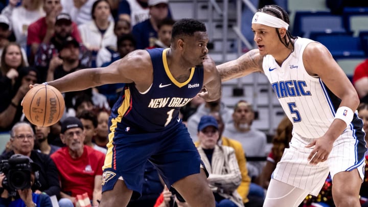 Apr 3, 2024; New Orleans, Louisiana, USA;  New Orleans Pelicans forward Zion Williamson (1) dribbles against Orlando Magic forward Paolo Banchero (5) during the first half at Smoothie King Center.