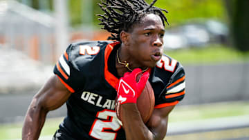 Delaware Hayes’s Favour Akih (2) runs the ball during the college football showcase at the Delaware Hayes High School on Wednesday, May 7, 2025 in Delaware, Ohio.