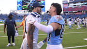 Nov 23, 2025; Nashville, Tennessee, USA; Seattle Seahawks wide receiver Jaxon Smith-Njigba (11) meets Tennessee Titans wide receiver Xavier Restrepo (87) after a game at Nissan Stadium. Mandatory Credit: Steve Roberts-Imagn Images