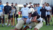 UCF wide receiver Waden Charles battles with Kam Moore during UCF Spring football practice at FBC Mortgage Stadium in Orlando, Friday, April 11, 2025.